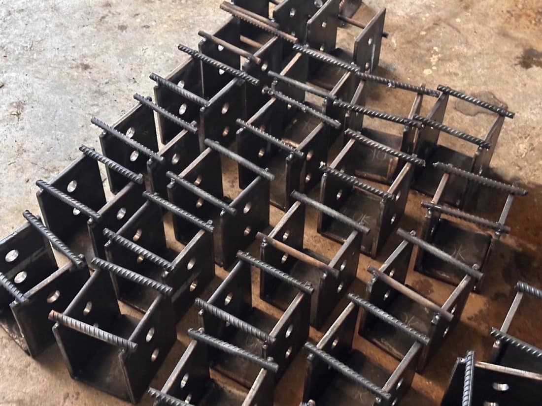 Prior plant work — batch of steel brackets with QC OK marks (not a Calma.Basic product)