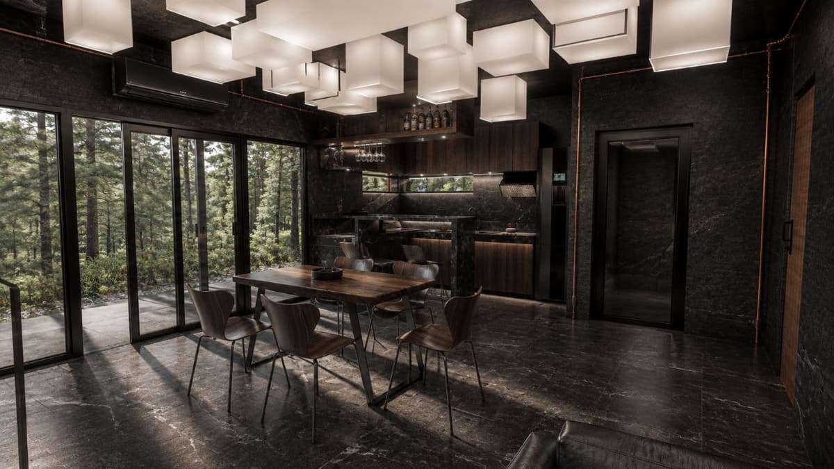 Calma.Basic black-skin dining and kitchen — charcoal stone, wood table, cube lantern ceiling