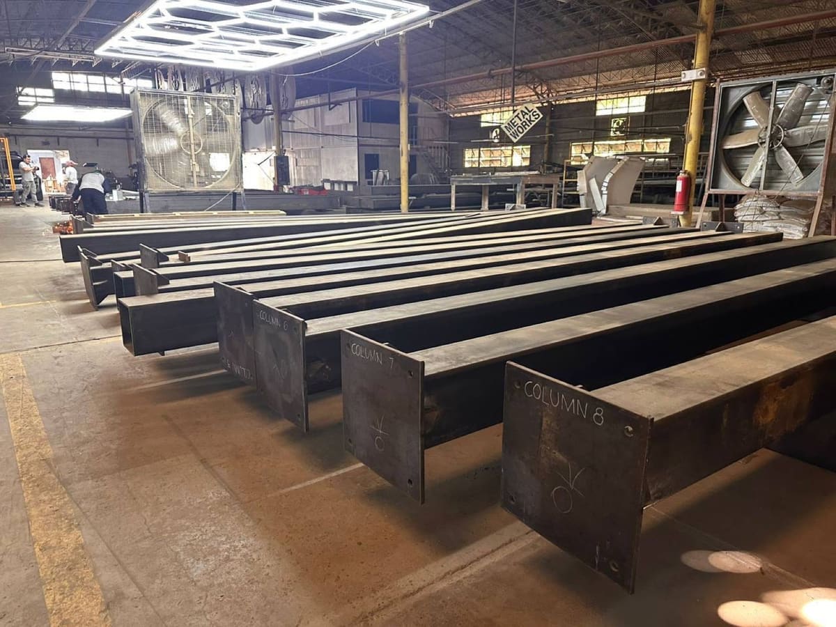 Calma.Basic plant — labeled structural columns with QC OK marks on the San Simon factory floor